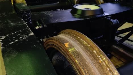 close up of train wagon and iron wheel under construction in factory