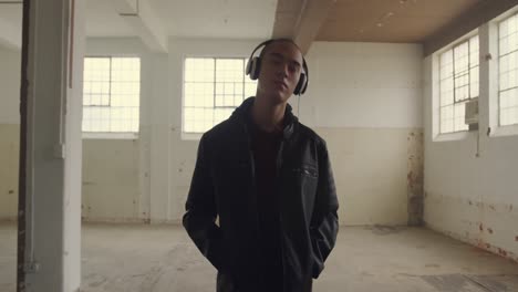 fashionable young man in an abandoned warehouse