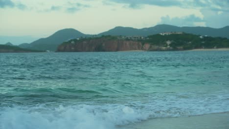 Static-shot-capturing-beauty-of-Baie-Rouge-Beach-with-continuous-waves-at-coastline-in-Saint-Martin