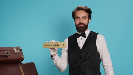 Hotel-worker-holds-restaurant-wall-sign