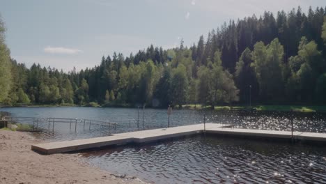 zoom in of jetty at kypesjön lake in late summer, borås sweden - wide shot