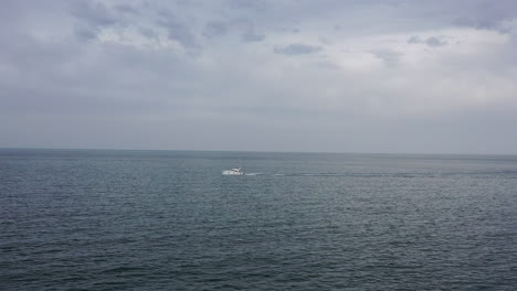 aerial shot traveling towards a motor leisure boat in the mediterranean sea