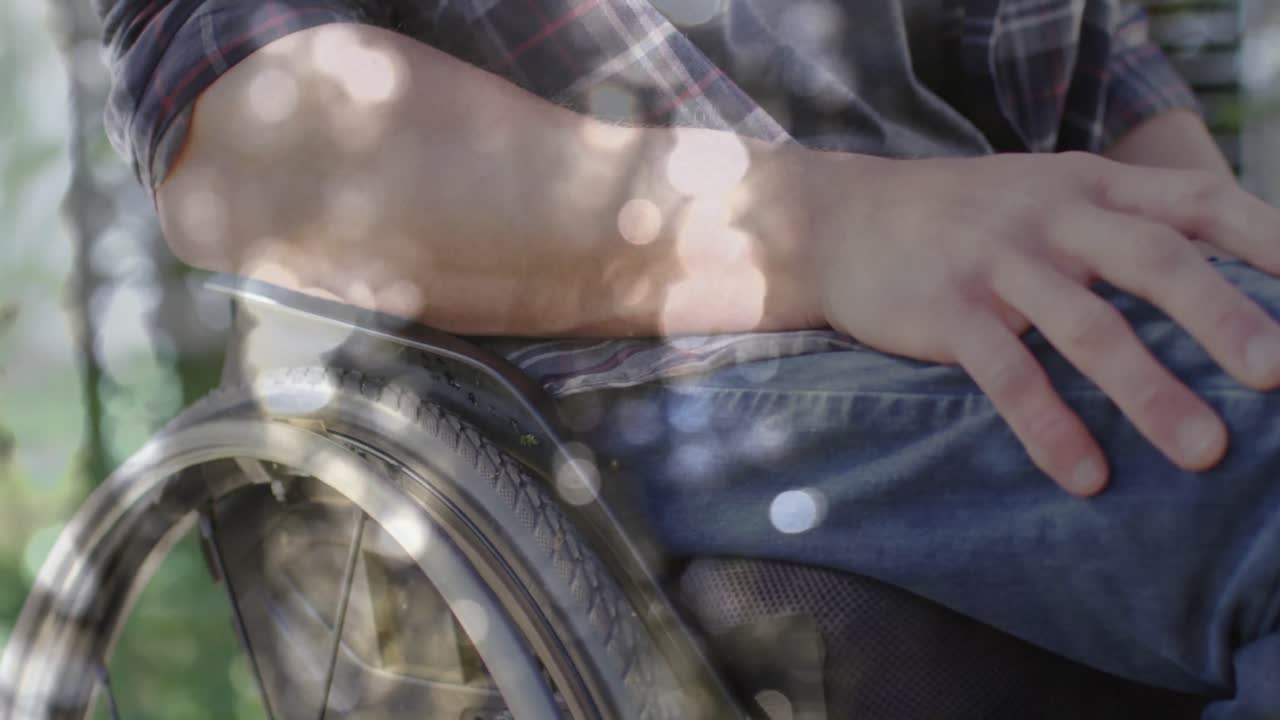 animación de puntos de luz sobre un hombre caucásico discapacitado sentado en silla de ruedas