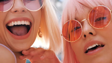 two friends laughing and wearing sunglasses