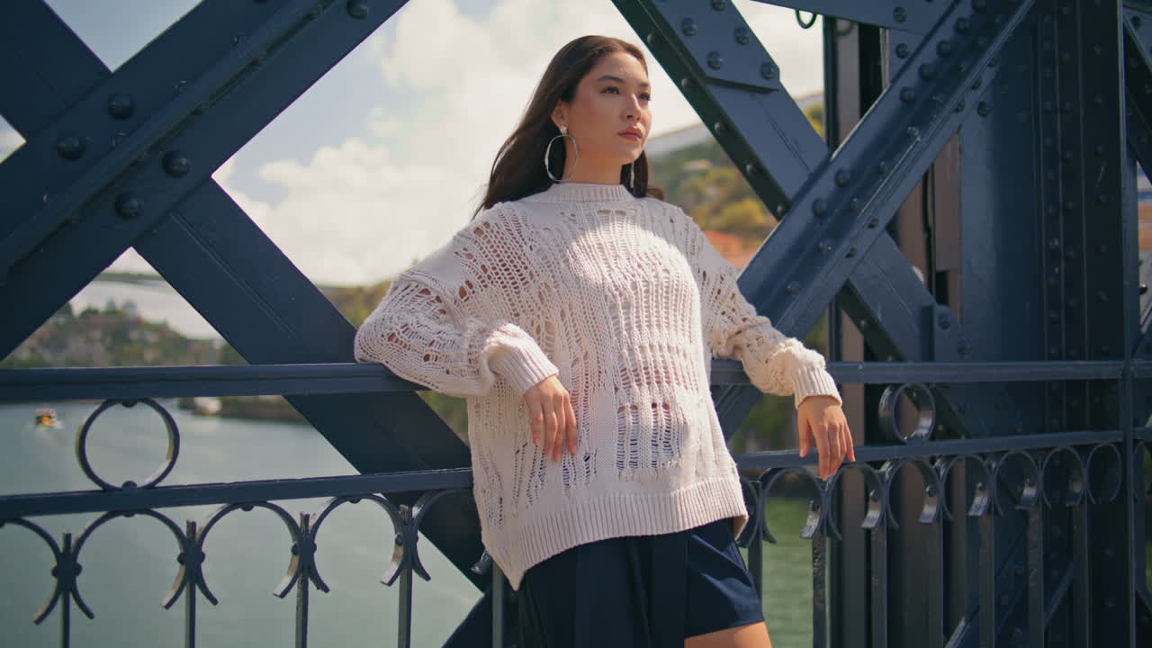 Confident woman leaning iron fence at summer vacation zoom on. Girl at bridge