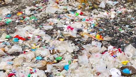 Fast-Panning-Shot-of-Big-Amounts-of-Plastic-Waste-on-the-Ground