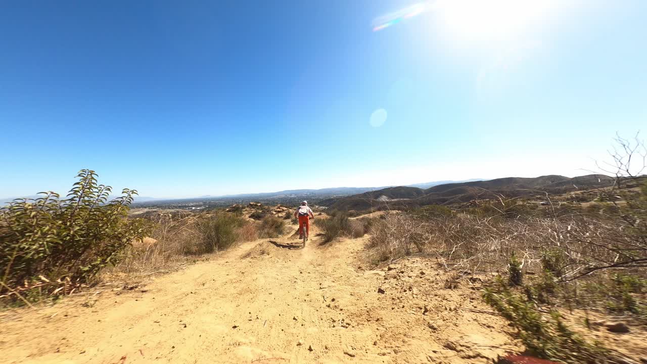 Drone high speed chase downhill mtb biker off ramps doing tricks