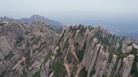 Overview-shot-of-the-unique-mountains-surrounding-the-Monestary-of-Montserrat-in-Spain,-Europe-by-drone