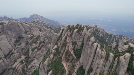 overview shot of the unique mountains surrounding the monestary of montserrat in spain, europe by drone