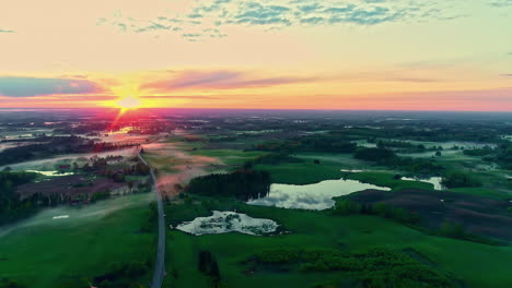 Sonnenaufgang-über-Einer-Wunderschönen-üppigen-Grünen-Ländlichen-Landschaft,-Während-Die-Ersten-Strahlen-Der-Sonne-Eine-Landschaft-Sanft-Erwärmen