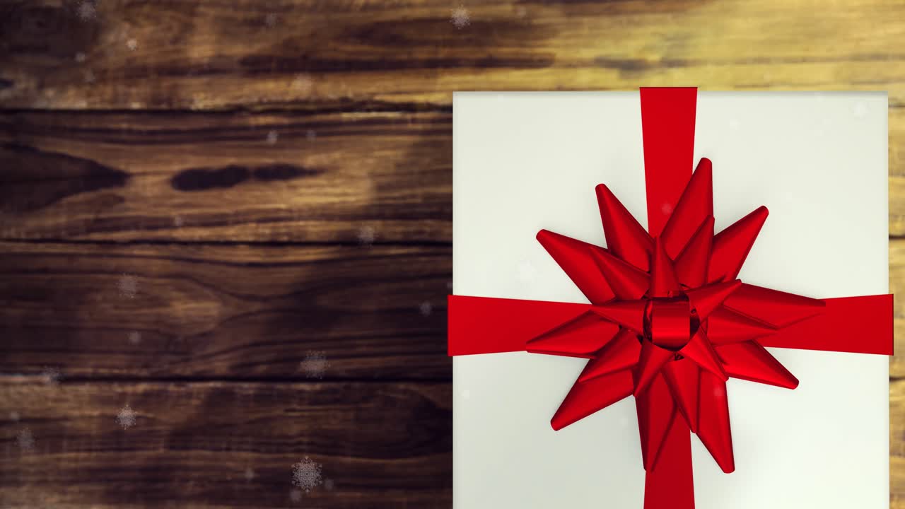 animación de la nieve cayendo sobre el presente en fondo de madera