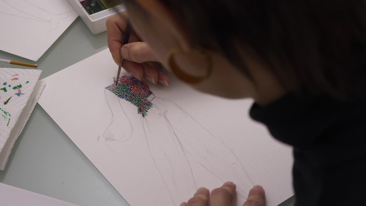 Fashion Designer Working On Colorful Clothing Design - high angle shot