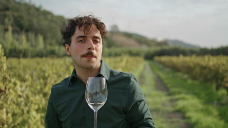 winegrower drinking wine vineyard vertical closeup. sommelier tasting alcohol