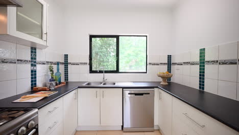 luxurious modern tiled floors interior design kitchen with gas stovetop black counters and decorative blue pattern backsplash