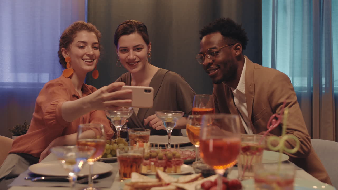 Multiethnic Group of Friends Taking Selfie Portrait at Dinner Table