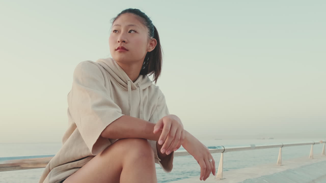Woman sitting near the sea