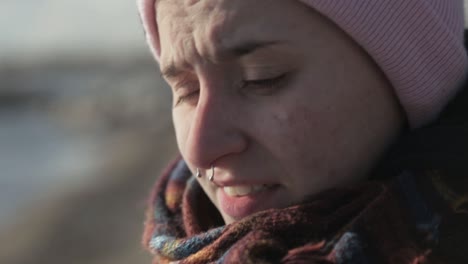 A-Young-Woman-Slightly-Chills-With-The-Cool-Breeze-From-The-Lakeshore---Close-Up-Shot