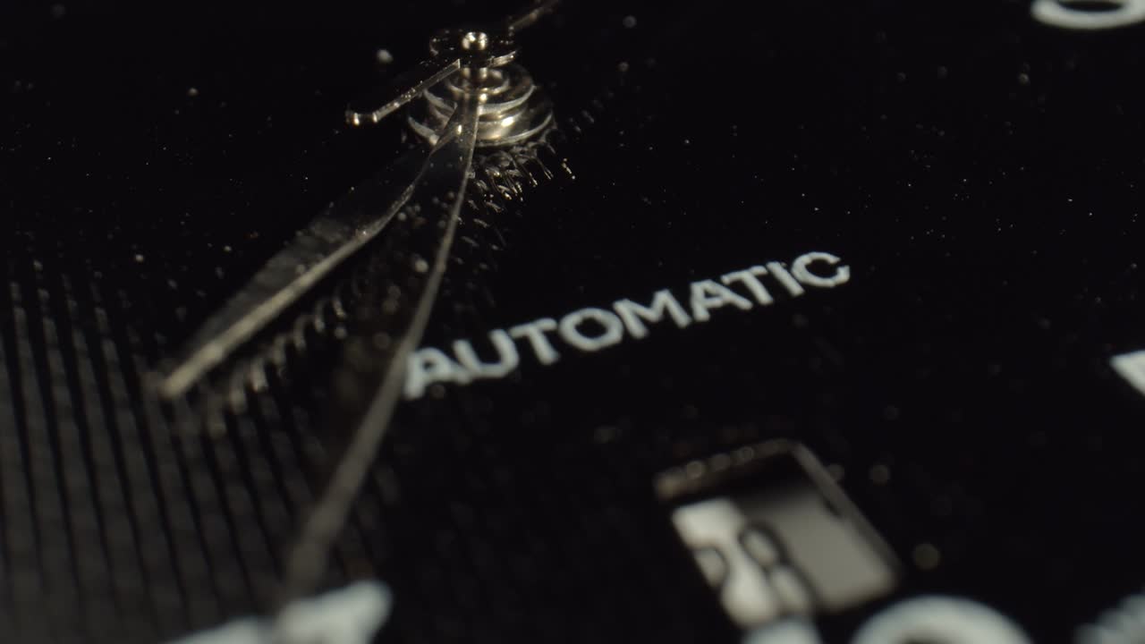 Wrist Watch with stopwatch. White numbers are printed on a black surface. Metal clock hands. Stopped time. Sale of watches.