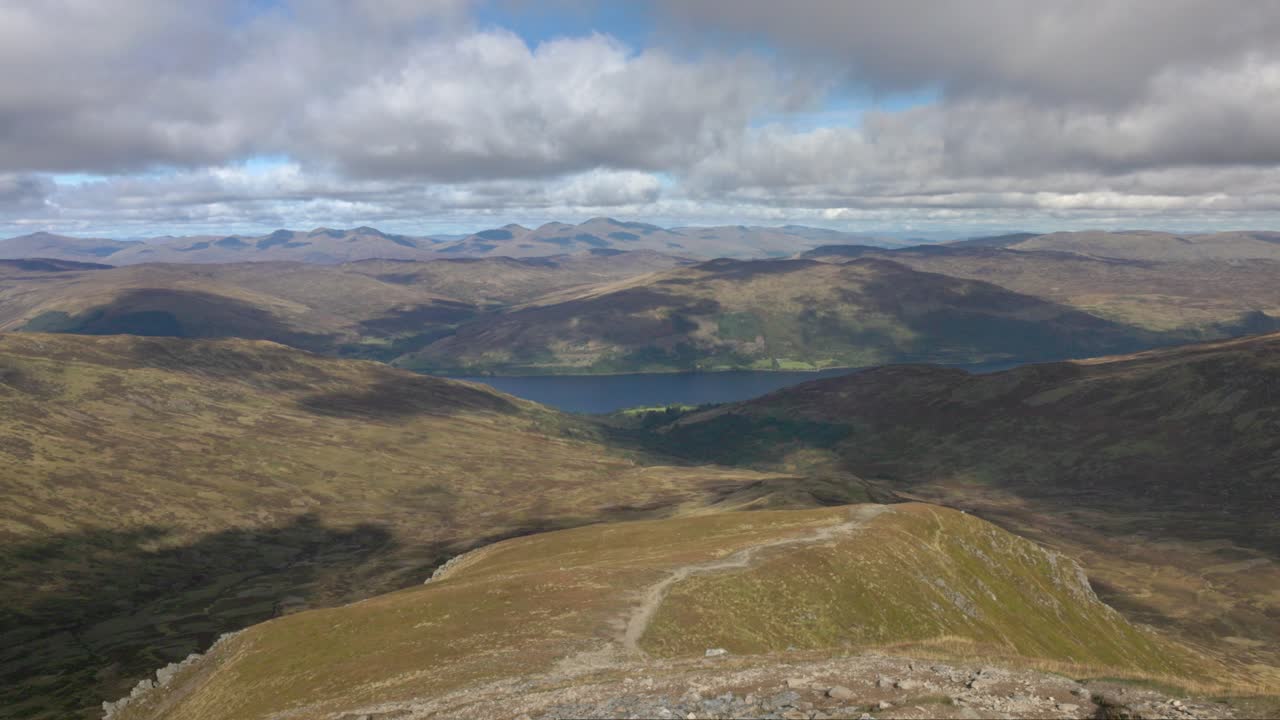 Slow panning shot of Loch Earn with mountain valleys from the Ben Vorlich summit