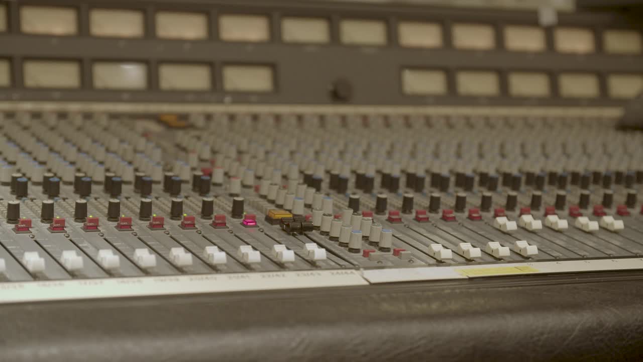 Recording studio - Vintage recording desk with engineer pressing talk back button