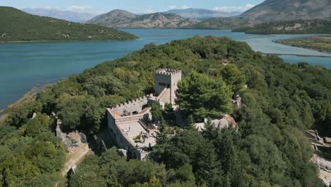 aerial circling shot of venetian castle in butrint archeological site