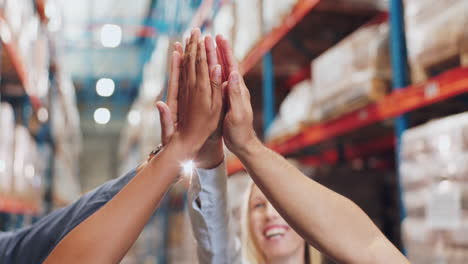 team high five in a warehouse