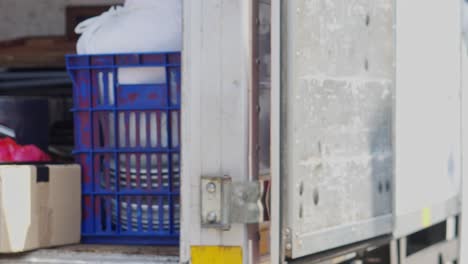 hands of delivery man gives postal package to customer near the delivery truck