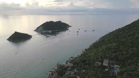 drone revealing scenic coastline island of koh tao nang yuan gulf of thailand aerial at sunset