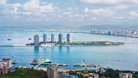 aerial footage of city skyline and buildings with sea natural scenery in hainan