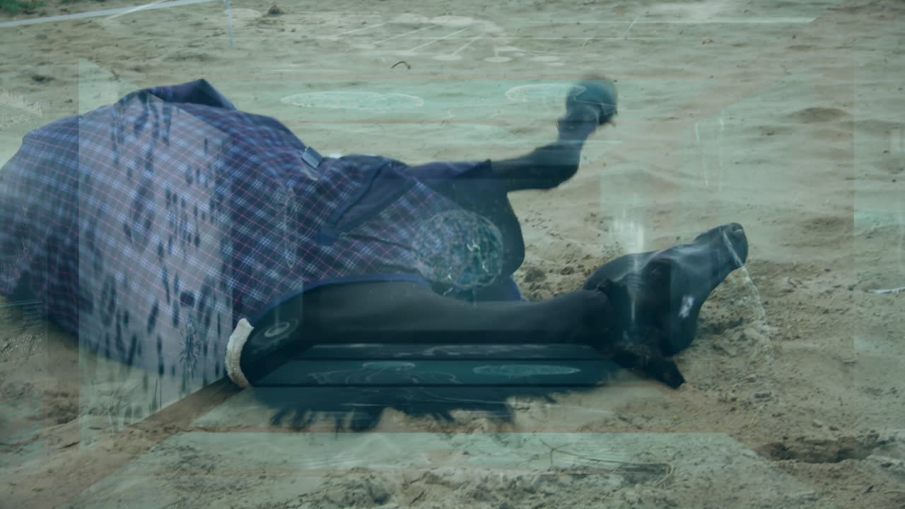 Person lying on sandy ground with digital data processing animation overlay