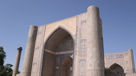 blue dome and minaret of mosque in registan square in samarkand, uzbekistan along the historic silk road