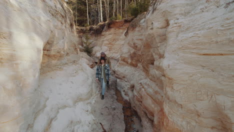 couple walking with dog through canyon