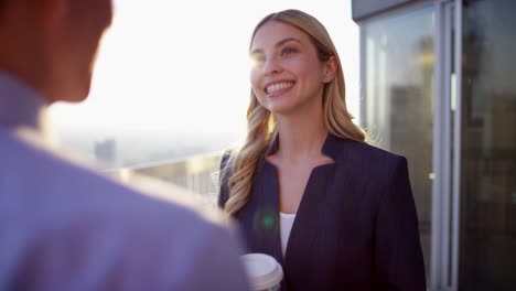 caucasian female and asian male colleague drinking coffee