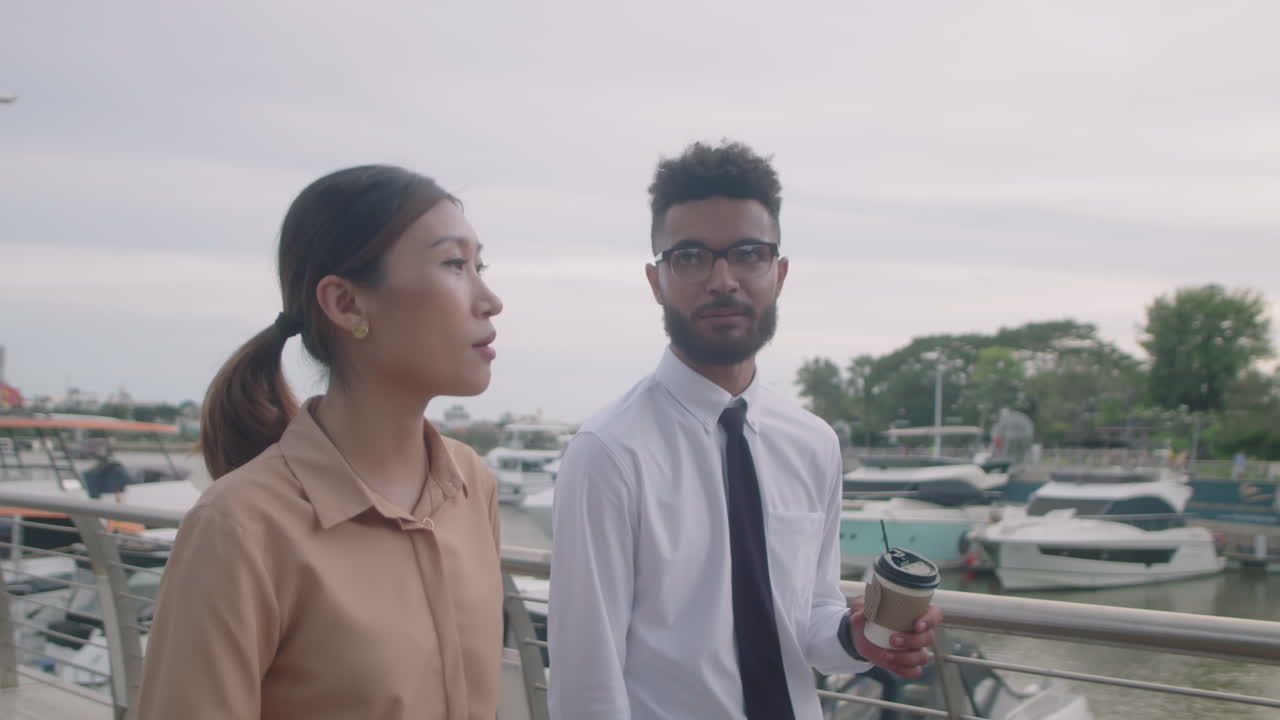 Colleagues Walking with Coffee and Having Talk