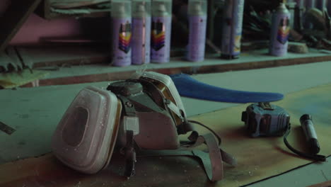 respirator mask, tape measure, paint, other diy workshop equipment on work bench