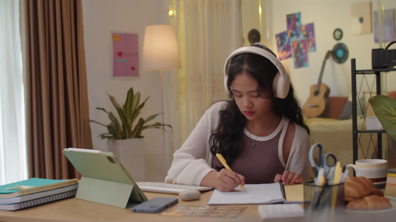 Asian Female Pupil Studying at Home Desk