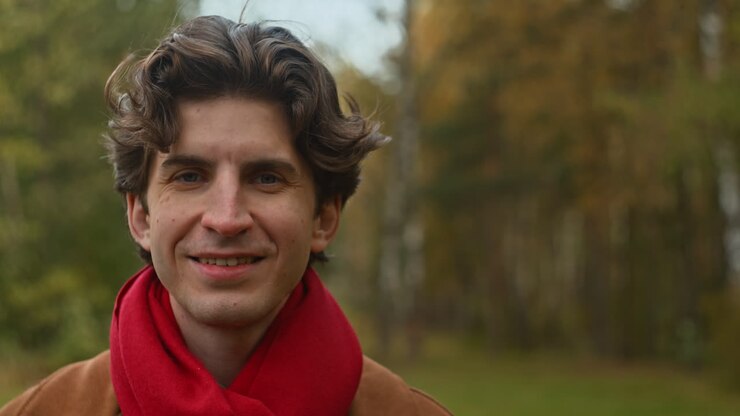 Portrait of a smiling man in autumn scenery