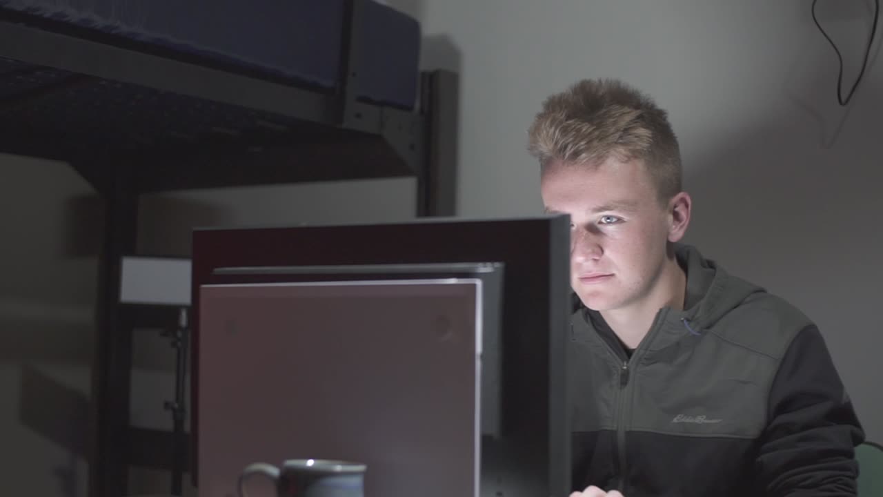 A right to left pan of a student at a computer