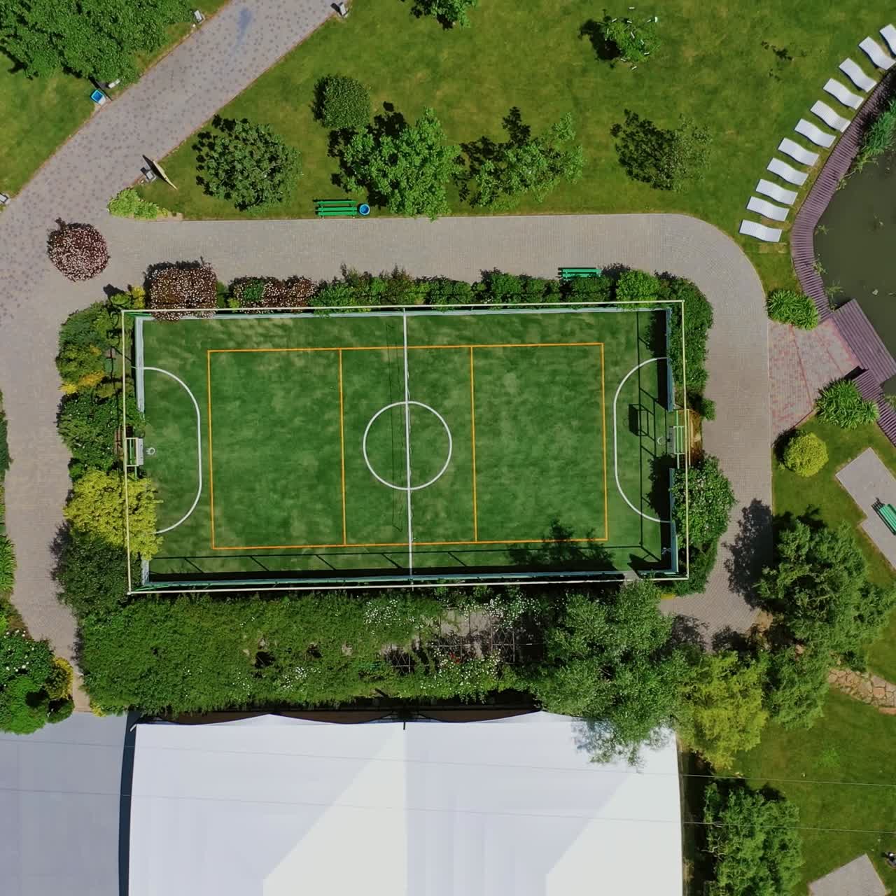 Small football pitch. Modern sportsground of the recreation complex among nature. Resort territory for summer vacation. Top view.