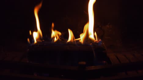 close up of burning log in fireplace