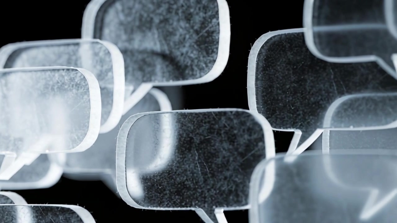 Floating frosted speech-bubble cluster shifting from camera pan in studio black, revealing rim glow