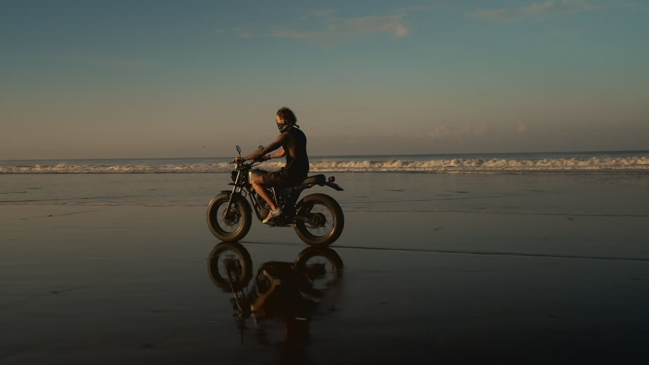 Man on Motorcycle at the Beach Sunset