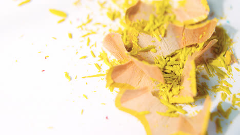 yellow color pencils shavings on a white background