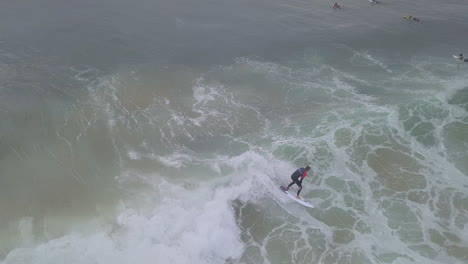 aerial of surfers surfing along exotic coast of south africa