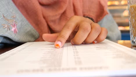 woman looking at a restaurant menu