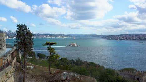 Boats-Passing-The-Bosphorus-Strait,-Construction-Workers-In-Foreground,-Bridge,-Istanbul,-Turkey