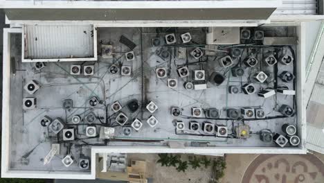 Aerial-top-down-of-AC-Fans-Units-on-Top-of-Residential-Building-summer-heat-concept