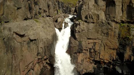 dramatic waterfall in a rocky canyon