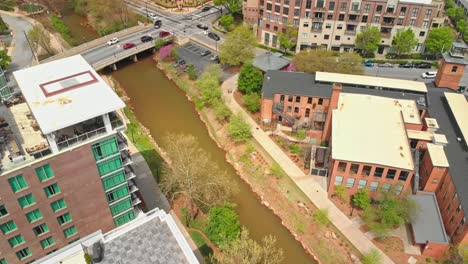 Aerial-drone-shot-of-city-buildings,-bridge,-and-river