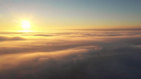 flying towards sun at sunrise above clouds like a bird, drone heavenly panorama